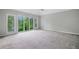 A spacious bedroom is brightly lit by a large window at 175 River Run, Roswell, GA 30075