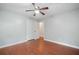 Bedroom with wood floors and view into ensuite bathroom at 175 River Run, Roswell, GA 30075