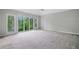 Bright bedroom boasts large windows offering serene outdoor views and a modern ceiling fan at 175 River Run, Roswell, GA 30075