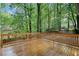 Spacious wooden deck with railings, perfect for outdoor entertaining and enjoying the surrounding nature at 175 River Run, Roswell, GA 30075