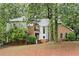 Charming two-story home with a mix of brick and stucco, surrounded by mature trees at 175 River Run, Roswell, GA 30075