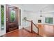 Bright foyer featuring a decorative front door, hardwood floors, and views of the living room at 175 River Run, Roswell, GA 30075