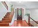 Welcoming foyer with hardwood floors, staircase, and a decorative front door with sidelights at 175 River Run, Roswell, GA 30075