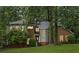 Beautifully landscaped front yard featuring lush grass, mature trees, and a charming two-story home at 175 River Run, Roswell, GA 30075