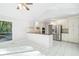 Open concept kitchen with white cabinets and stainless steel appliances at 175 River Run, Roswell, GA 30075