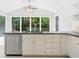 Kitchen island with stainless steel dishwasher and backyard view at 175 River Run, Roswell, GA 30075
