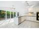 Bright kitchen with stainless steel appliances, island, and a large window overlooking backyard at 175 River Run, Roswell, GA 30075