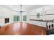 Open-concept living area with hardwood floors, fireplace, large windows and staircase access at 175 River Run, Roswell, GA 30075