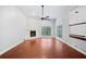 Bright living room with hardwood floors, fireplace, and large windows offering natural light at 175 River Run, Roswell, GA 30075