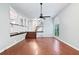 Spacious living room with hardwood floors, a ceiling fan, and ample natural light at 175 River Run, Roswell, GA 30075