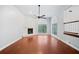 Bright living room featuring hardwood floors, a fireplace, and large windows at 175 River Run, Roswell, GA 30075