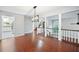 Open concept living room featuring hardwood floors, modern chandelier, and staircase access at 175 River Run, Roswell, GA 30075