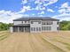 Two-story home with a covered patio overlooking a spacious backyard and wooded area at 2021 Jones Phillips Rd, Dacula, GA 30019