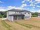 Rear view of a two-story home featuring a covered patio and expansive backyard at 2021 Jones Phillips Rd, Dacula, GA 30019
