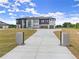Long concrete driveway leading up to a modern two-story home with three-car garage at 2021 Jones Phillips Rd, Dacula, GA 30019