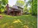 Large backyard featuring a deck, mature trees, and green grass at 351 Ridgewater Dr, Marietta, GA 30068