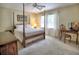 Cozy bedroom with a four-poster bed, white carpet, and a desk near the window at 351 Ridgewater Dr, Marietta, GA 30068