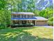 Charming two-story home with a well-manicured lawn, mature trees, and attached two car garage at 351 Ridgewater Dr, Marietta, GA 30068