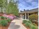 Charming exterior view of the pool house, surrounded by blooming azaleas and manicured greenery at 351 Ridgewater Dr, Marietta, GA 30068