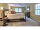 Spacious main bedroom with a king-sized bed, dresser, and windows at 351 Ridgewater Dr, Marietta, GA 30068