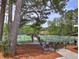 View of tennis courts framed by a large tree and landscaped area with stairs leading to the courts at 351 Ridgewater Dr, Marietta, GA 30068