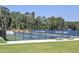 Walton High School's tennis courts with sports banners and shaded benches surrounded by greenery at 351 Ridgewater Dr, Marietta, GA 30068