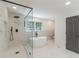 This is a bathroom with a glass shower, modern soaking tub, and marble flooring at 418 Mockingbird, Smyrna, GA 30082