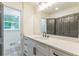 Bathroom with a gray vanity with stone countertops, gray door, and tile floor at 418 Mockingbird, Smyrna, GA 30082