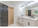 This is a bathroom with double sinks, plenty of cabinet space, and a large mirror at 418 Mockingbird, Smyrna, GA 30082