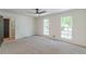 This is a well-lit bedroom with a ceiling fan and two windows overlooking the yard at 418 Mockingbird, Smyrna, GA 30082
