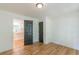 Bedroom with hardwood floors and view into the kitchen through doorway with dark doors at 418 Mockingbird, Smyrna, GA 30082