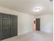 Carpeted bedroom featuring double doors and a glimpse of a bath at 418 Mockingbird, Smyrna, GA 30082
