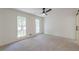 Bedroom with two large windows, neutral carpet, and sliding barn door at 418 Mockingbird, Smyrna, GA 30082