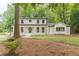 Beautiful two-story home with a white brick exterior, black trim, and a welcoming front porch at 418 Mockingbird, Smyrna, GA 30082