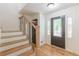 Inviting foyer featuring a staircase, hardwood floors, and a stylish front door with decorative glass panels at 418 Mockingbird, Smyrna, GA 30082
