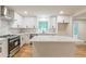 Modern kitchen boasts stainless steel appliances, white cabinets, and center island with quartz countertop at 418 Mockingbird, Smyrna, GA 30082