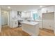 Bright kitchen features white cabinets, stainless steel appliances, and an island with quartz countertop at 418 Mockingbird, Smyrna, GA 30082