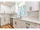 Bright kitchen features white cabinetry, stainless steel appliances, and gray subway tile backsplash at 418 Mockingbird, Smyrna, GA 30082