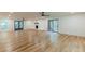 Open living room featuring hardwood floors, fireplace, and double glass door access to the outside at 418 Mockingbird, Smyrna, GA 30082