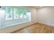 Bright living room with hardwood floors and a large window seat at 418 Mockingbird, Smyrna, GA 30082