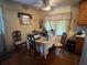 Cozy dining area with hardwood floors, complemented by natural light, and traditional decor at 8118 Sw Collier Sw St, Covington, GA 30014