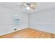Bright bedroom with hardwood floors and a large window offers a comfortable and inviting space at 8914 Gardener Dr, Jonesboro, GA 30238
