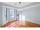 Bright dining area with large windows and hardwood floors under a modern light fixture at 8914 Gardener Dr, Jonesboro, GA 30238
