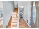 Inviting entryway showcases hardwood floors, a staircase, and a view of the kitchen at 8914 Gardener Dr, Jonesboro, GA 30238