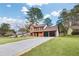 Captivating home with a large, well-manicured lawn and long driveway leading to a three-car garage at 8914 Gardener Dr, Jonesboro, GA 30238