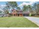 Classic brick home features a large lawn and a convenient three-car garage at 8914 Gardener Dr, Jonesboro, GA 30238