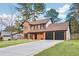 Attractive exterior view of a brick home with a three-car garage and newly paved driveway at 8914 Gardener Dr, Jonesboro, GA 30238