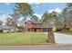 Attractive exterior view features a brick home with a spacious lawn and private driveway at 8914 Gardener Dr, Jonesboro, GA 30238