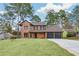 Charming brick home boasts mature trees, fresh lawn, and a three-car garage at 8914 Gardener Dr, Jonesboro, GA 30238