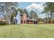 Attractive brick home featuring a well-manicured lawn, and attached three-car garage at 8914 Gardener Dr, Jonesboro, GA 30238